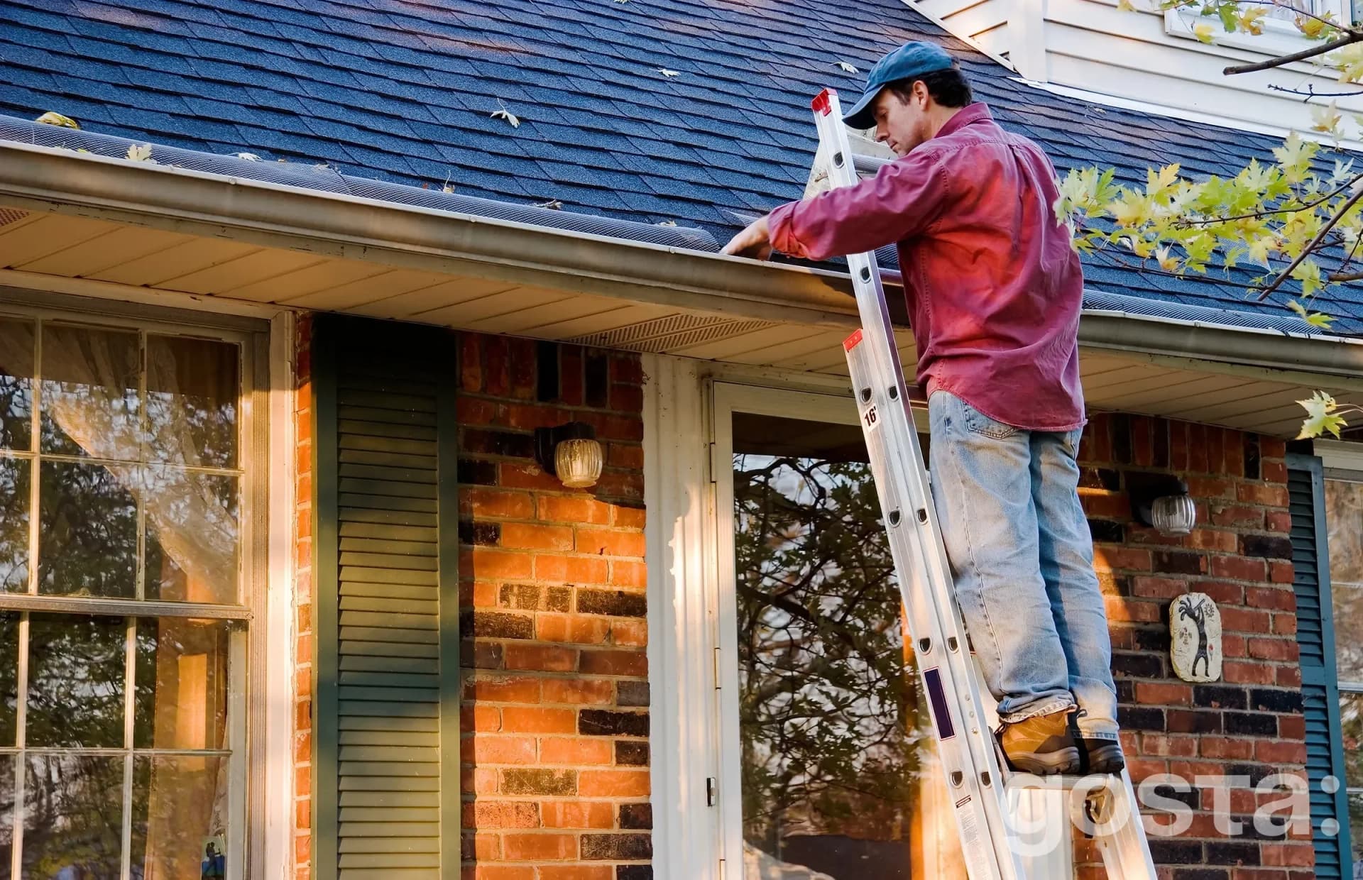 Homeowner visually inspecting a roof from the ground in spring