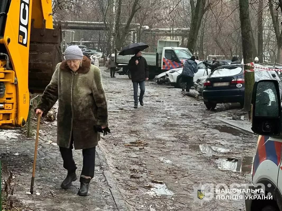 Emergency responders assist after a missile attack in Dnipro, Ukraine, helping injured civilians, including children.