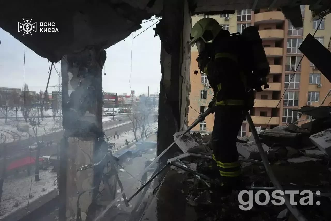 Emergency responders in Kyiv assess damage from a missile strike, highlighting the impact of the ongoing conflict in Ukr