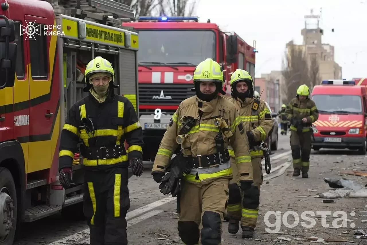 Emergency responders in Kyiv responding to the aftermath of a Russian attack, focusing on firefighting and rescue effort