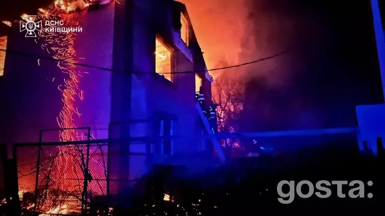 Firefighters extinguish flames in Kyiv amid destruction from a massive Russian attack, rescuing affected residents.