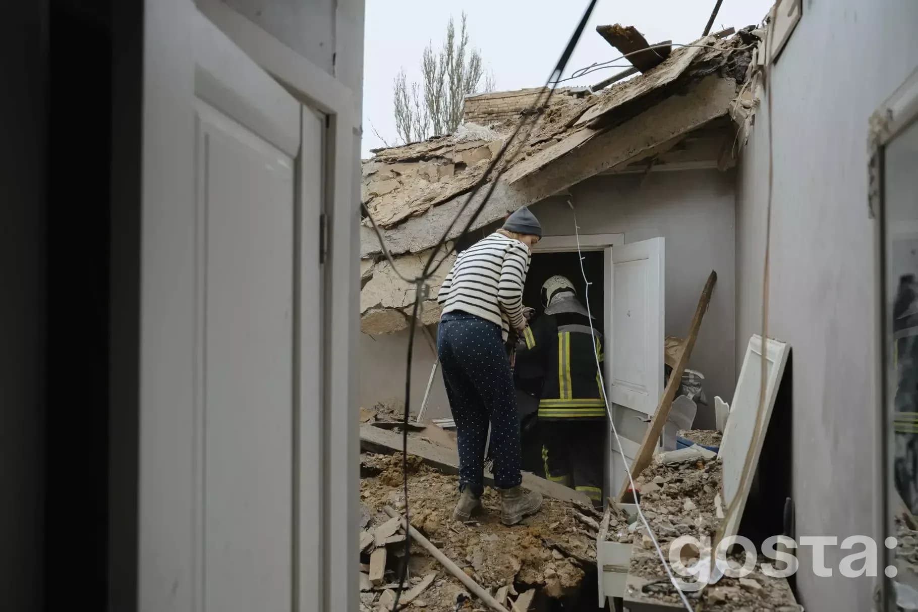 Rescue workers respond to damage in Kyiv after recent attacks, aiding residents in need amidst ongoing emergency efforts
